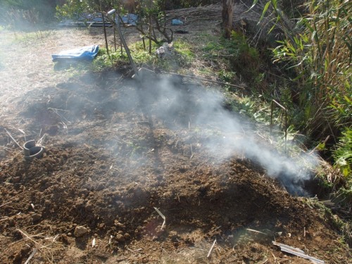 煙突（写真左）からは煙が出ず、焚き口の煙がそのまま外に流れていく。